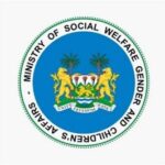 Official seal of the Ministry of Social Welfare, Gender and Children’s Affairs, featuring a blue shield with palm trees and two gold lions near a water scene.